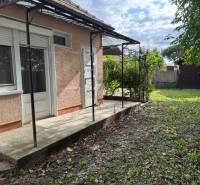 Family house in Komárno with a terrace and a grassy yard on a sunny plot.