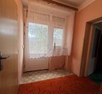 Interior of a family house with doors and curtains on the window, floor with checkered design.