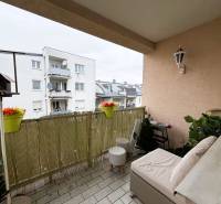 A balcony in a 3-room apartment with a view of a building in the town of Kittsee.