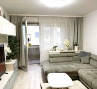 Living room in a 3-room apartment with a comfortable sofa corner and a wooden decor floor.