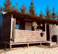 A wooden cabin surrounded by trees on Prosačov Street in the town of Prosačov, construction of houses.