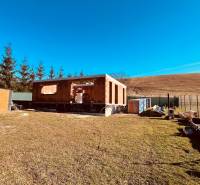 Construction of houses in Prosačov on Prosačová Street surrounded by nature and a clear sky.