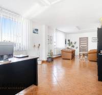 Bright commercial spaces with chairs, tables, and decorations on a floor with a wooden decor.