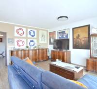 Living room in a 3-room apartment with a wooden decor floor and stylish furniture.