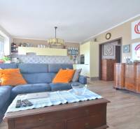 Living room with a blue sofa, wooden decor flooring, 3-room apartment.