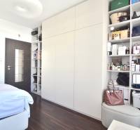 Bedroom in a 3-room apartment with storage spaces and a floor with a wooden decor.