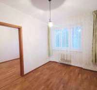 A room with curtains, a wooden floor design, and a window in a 4-room apartment.
