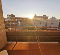 The balcony of a 4-room apartment on Priekopnícka Street in Bratislava - Podunajské Biskupice at sunset.