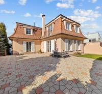 Family house in Bratislava-Záhorská Bystrica with a paved courtyard and a landscaped garden.