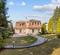 A family house in Bratislava - Záhorská Bystrica with a well-maintained garden and walkway.