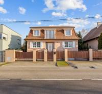A family house in Bratislava - Záhorská Bystrica with a red tiled roof and white shutters.