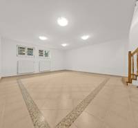 Interior with ceramic tiles, staircase, and radiators in a family house.