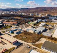 Aerial view of commercial land in Bratislava - Vajnory with industrial buildings and nature.