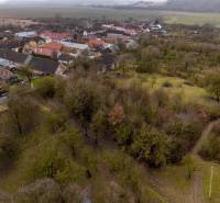 View of recreational plots in Gemerské Teplice with numerous trees and houses.