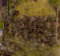 Aerial view of forest recreational plots near Gemerské Teplice with a grassy area.