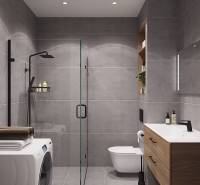 Bathroom in a studio apartment with a washing machine, shower, and wooden decor furniture.