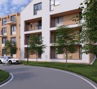 Apartment building in Poprad with a ramp, cyclist, and landscaped surroundings with greenery.