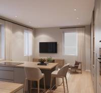 A kitchen in a studio apartment with an island and a wooden decor floor.