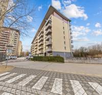 Apartment building on Nejedlého Street, Bratislava - Dúbravka, with balconies and a leafless tree.
