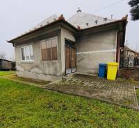 A family house on Seredska Street in Hlohovec with a small garden and a paved access area.