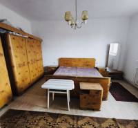 Bedroom in a family house with furniture, wooden decor flooring, carpet, lamp.