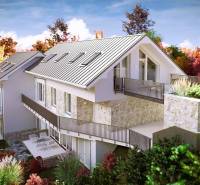 A family house in the High Tatras with a stone facade and a terrace surrounded by autumn nature.