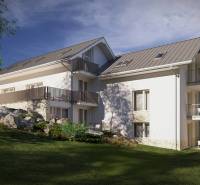 Exterior of a building in the High Tatras, surrounded by greenery and rocky terrain.
