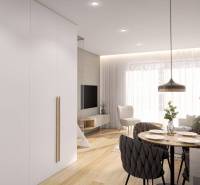 Dining room with wood-patterned flooring in a studio apartment, a bright and functional space.