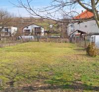 The garden at the family house in Gemerský Jablonec with a view of the surrounding houses and fruit trees.