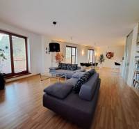 Living room in a two-room apartment with a sofa and a wooden decor floor.