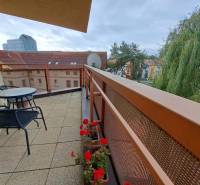 The balcony of a 2-room apartment on Štefánikova Street in Poprad with a view of the trees.