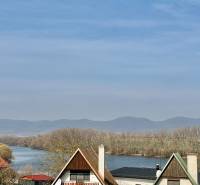 A view of a family house in Suchá nad Parnou, Nové Vinohrady Street, near the river and mountains.