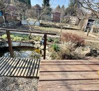 Wooden table and garden bridge in the yard of a family house in Nové Vinohrady, Suchá nad Parnou.