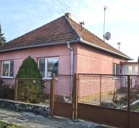 A family house on Martinová Street in Lúčnica nad Žitavou with a landscaped garden and a gate.