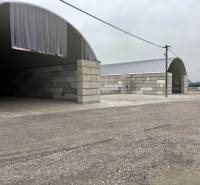 Warehouses and halls in the town of Ladce with arched roofs and concrete walls.