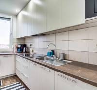 A kitchen with a spacious countertop in a 2-room apartment, with accessories on the work surface.