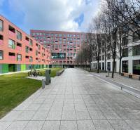 New buildings with colorful facades on Košická Street in Bratislava - Nivy, surrounded by greenery.