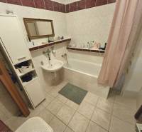 Bathroom in a 3-room apartment with a bathtub, sink, and storage space.