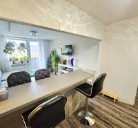 3-room apartment with a bar counter and comfortable seating, floor with wooden decor.