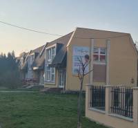 Houses with flat roofs on Gen. Klapka Street in Komárno, surrounded by greenery. Commercial spaces.