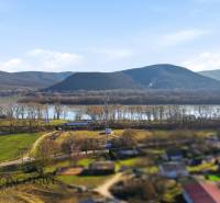A view of the landscape with hills, a river, and a village near Štúrovo on Kováčov Street.