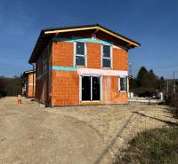 An unfinished family house on Lesná Street in Stupava, without a facade, sunny day.