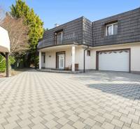 A family house in Ivanka pri Dunaji with a pitched roof and a garage on a paved yard.