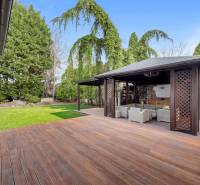 A family house in Ivanka pri Dunaji with a garden and a gazebo next to a floor with a wooden decor.