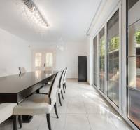 Dining room in a family house with a long table and a view of the terrace.