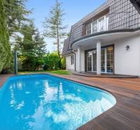 A family house in Ivanka pri Dunaji with a swimming pool and a garden floor with a wooden decor.