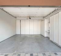 A garage with white walls and a concrete floor in a family house in Ivanka pri Dunaji.