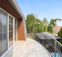 A balcony of a family house in Ivanka pri Dunaji with a metal railing and a view of the garden.