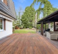 A family house in Ivanka pri Dunaji with a terrace made of flooring with a wooden decor and a garden.