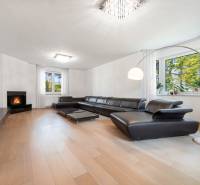 Living room in a family house with a leather sofa and a wooden decor floor.